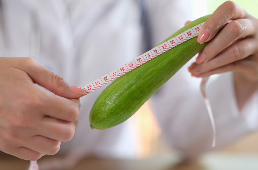 Person measuring a squash with a ruler