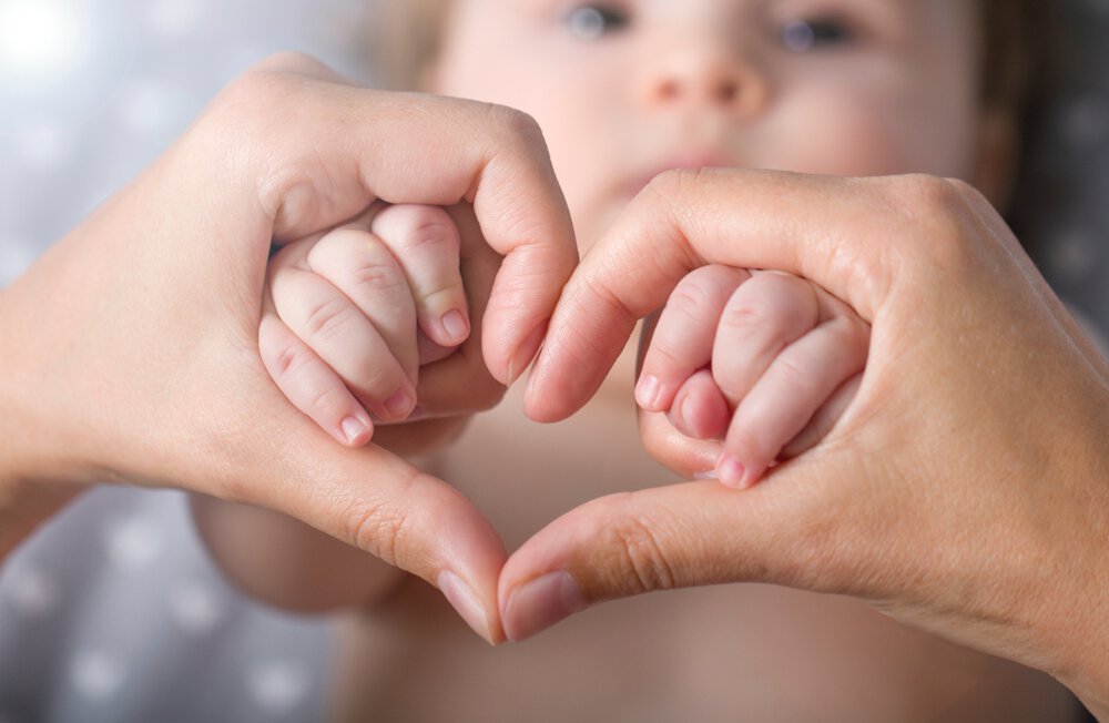 Heart shaped around baby hands